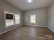 Bright bedroom with three windows and wood-look flooring at 312 W Henderson St, Salisbury, NC 28144