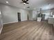 Open concept living room with wood-look floors flowing into a modern kitchen at 312 W Henderson St, Salisbury, NC 28144