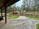 A cozy backyard with stone landscaping and stairs leads to a charming house and shed in a wooded area at 3452 Odell School Rd, Concord, NC 28027