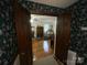 Open doorway leading into a bedroom with hardwood floors and a fireplace that provides warmth at 3452 Odell School Rd, Concord, NC 28027