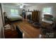 Bedroom featuring wood floors, ceiling fan, fireplace, and large windows bringing in natural light at 3452 Odell School Rd, Concord, NC 28027