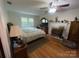 Bright bedroom features hardwood floors, fireplace, and windows that provide plenty of natural light at 3452 Odell School Rd, Concord, NC 28027