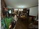 Dining room with wood floors, brick accent wall, and view of kitchen at 3452 Odell School Rd, Concord, NC 28027