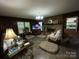 Spacious living room with brick fireplace, large windows, and ample natural light at 3452 Odell School Rd, Concord, NC 28027