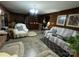 Comfortable living room featuring classic wood paneling and lots of natural light at 3452 Odell School Rd, Concord, NC 28027