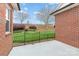 Backyard with brick exterior, small gated fence, and lawn at 3921 Sage Ct, Denver, NC 28037