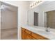 Bright bathroom featuring a single vanity, large mirror, and doorway leading to another room at 3921 Sage Ct, Denver, NC 28037
