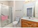 Bathroom featuring a glass enclosed shower, white toilet, and a wooden vanity with marble top at 3921 Sage Ct, Denver, NC 28037