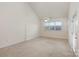 Bright bedroom with vaulted ceilings, ceiling fan, neutral carpet and lots of natural light through the large window at 3921 Sage Ct, Denver, NC 28037