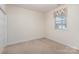 Bedroom featuring neutral carpeting, a window with floral valance, and double door closet at 3921 Sage Ct, Denver, NC 28037