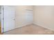 Bedroom featuring neutral carpeting, double door closet, and white painted trim at 3921 Sage Ct, Denver, NC 28037