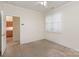 Neutral bedroom with a ceiling fan, access to kitchen, and a bright window at 3921 Sage Ct, Denver, NC 28037