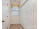 Entry hallway with tile flooring, closet, and a bright window with valence at 3921 Sage Ct, Denver, NC 28037