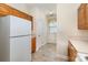 Well-lit kitchen featuring oak cabinets, neutral countertops, and a white refrigerator at 3921 Sage Ct, Denver, NC 28037