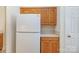Kitchen featuring oak cabinets, white appliances, and a side-by-side refrigerator at 3921 Sage Ct, Denver, NC 28037