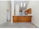 Open-concept living space with kitchen bar and access to another room, illuminated by skylights at 3921 Sage Ct, Denver, NC 28037
