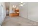 Bright living room with a bar counter, ceiling fan, and skylights, offering a welcoming and airy atmosphere at 3921 Sage Ct, Denver, NC 28037