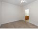 Spacious main bedroom with neutral carpet, chair rail, and access to the main bathroom at 3921 Sage Ct, Denver, NC 28037