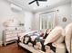 Cozy bedroom with hardwood floors, black floral bedding, dresser, and a bright window at 4012 Flagstone Dr, Lancaster, SC 29720