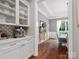 View of the butler's pantry leading into a dining room with hardwood floors and natural light at 4012 Flagstone Dr, Lancaster, SC 29720