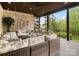Inviting covered deck with comfortable seating, brick wall accents, and serene outdoor views at 4012 Flagstone Dr, Lancaster, SC 29720