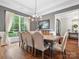Dining room with hardwood floors, chandelier, large window, and seating for six near a side cabinet at 4012 Flagstone Dr, Lancaster, SC 29720