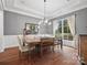 Elegant dining room with hardwood floors, chandelier, large window, and stylish dining set at 4012 Flagstone Dr, Lancaster, SC 29720