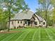 Beautifully landscaped front yard with a traditional brick home featuring a covered front porch at 4012 Flagstone Dr, Lancaster, SC 29720