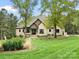 Stately brick home on a lush green lawn, featuring an inviting entrance and mature trees at 4012 Flagstone Dr, Lancaster, SC 29720