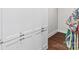 Hallway features white cabinets with sleek silver pulls on wood floors, and a hint of decor at 4012 Flagstone Dr, Lancaster, SC 29720