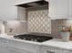 Kitchen features a cooktop, tile backsplash, custom cabinetry, and stainless steel appliances at 4012 Flagstone Dr, Lancaster, SC 29720
