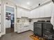 Well-equipped laundry room with white cabinetry, utility sink, and stainless steel washer/dryer at 4012 Flagstone Dr, Lancaster, SC 29720