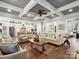 Bright and spacious living room with hardwood floors, coffered ceiling, and easy access to kitchen area at 4012 Flagstone Dr, Lancaster, SC 29720