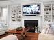 Cozy living room with built-in shelves, a fireplace, and comfortable seating arrangements and wood floors at 4012 Flagstone Dr, Lancaster, SC 29720