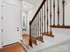 Elegant staircase with dark wood railing and white risers, leading to upper levels of the home at 4012 Flagstone Dr, Lancaster, SC 29720