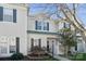 Charming townhome exterior showcasing neutral siding, dark shutters, and a well-kept front yard at 4211 Center Place Dr, Harrisburg, NC 28075