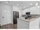 Bright kitchen with white cabinetry, stainless steel refrigerator, and granite countertops at 4211 Center Place Dr, Harrisburg, NC 28075