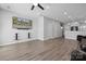 Bright living room with hardwood floors, mounted TV, and an open view of the kitchen at 4211 Center Place Dr, Harrisburg, NC 28075