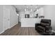 Open-concept living space featuring hardwood floors and a comfortable chair at 4211 Center Place Dr, Harrisburg, NC 28075