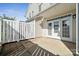 Exterior view of the rear patio featuring white vinyl fence and white framed glass doors at 4211 Center Place Dr, Harrisburg, NC 28075