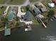 Waterfront property showcasing a private dock and lovely landscaping at 428 Pinehaven Dr, New London, NC 28127