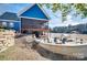 Beautiful backyard with lake, patio, outdoor furniture, and a charming screened-in porch for relaxing and entertaining at 428 Pinehaven Dr, New London, NC 28127