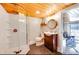 Bathroom featuring glass enclosed shower, dark vanity, decorative mirror, and hexagon tile flooring at 428 Pinehaven Dr, New London, NC 28127