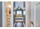 Light and airy bedroom features a walk through view with bathroom and modern decor at 428 Pinehaven Dr, New London, NC 28127