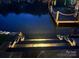 Illuminated lake view from a dock with stone stairs at night at 428 Pinehaven Dr, New London, NC 28127
