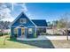 Charming blue home with a well-manicured lawn and a view of the lake at 428 Pinehaven Dr, New London, NC 28127