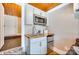 Kitchenette featuring white cabinetry, butcher block countertop, stainless microwave and refrigerator, and tile flooring at 428 Pinehaven Dr, New London, NC 28127