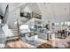 Open-concept living room with high vaulted ceilings, hardwood floors, a large sectional sofa, and stair access at 428 Pinehaven Dr, New London, NC 28127