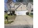 Charming two-story home with a two car garage, manicured lawn, and a traditional mailbox at 4831 Belmar Place Rd, Charlotte, NC 28269