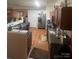 Functional kitchen features wood-look floors, stainless-steel appliances, and wood cabinetry at 4831 Belmar Place Rd, Charlotte, NC 28269